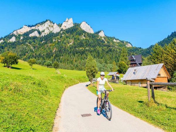 Young woman cycling near Trzy Korony