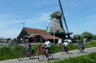 cyclists near windmill