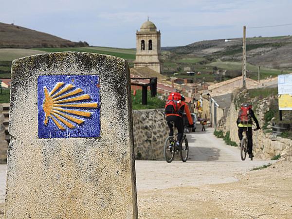 Cyclists on the St James way in an old village